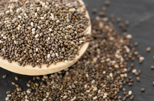 Raw chia seeds in a wooden bowl