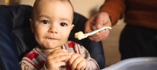 Baby eating with a spoon