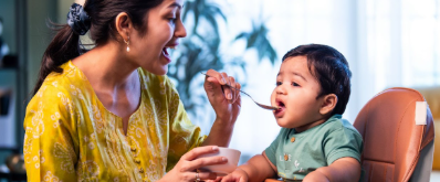 Mother feeding baby with love