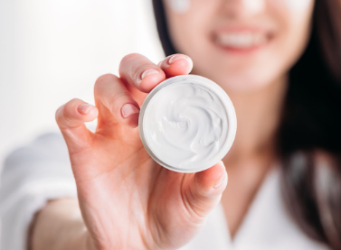 Woman holding skin cream jar